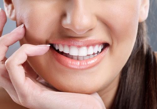 a smiling woman showing half her face